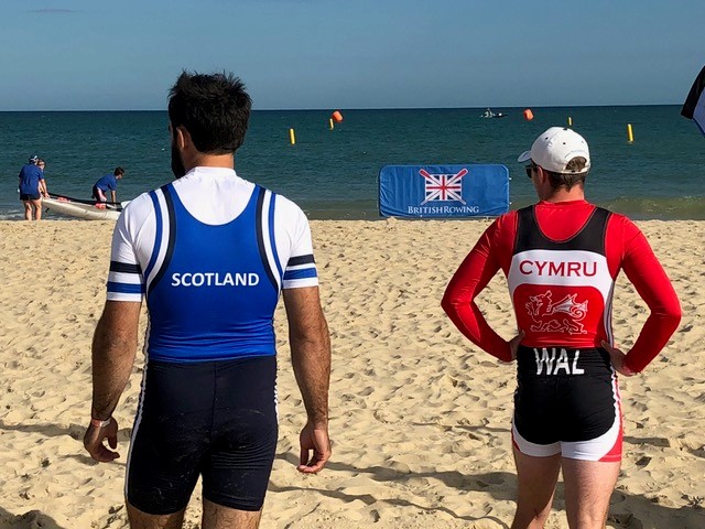 Image of 2 rowers on a beach 